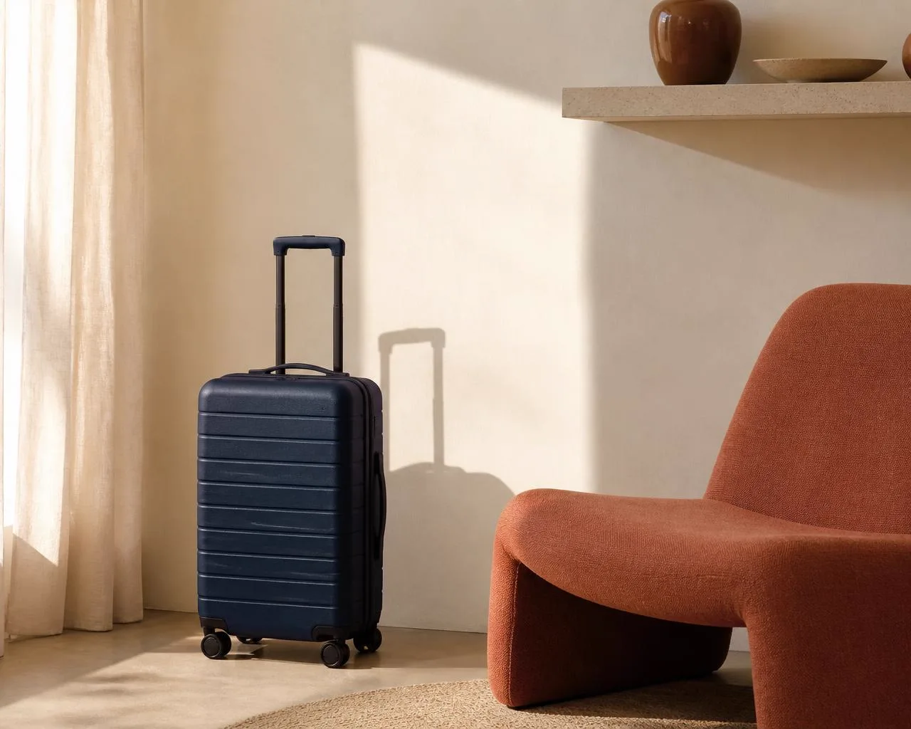 Rivetd carry-on suitcase in a warm minimal interior